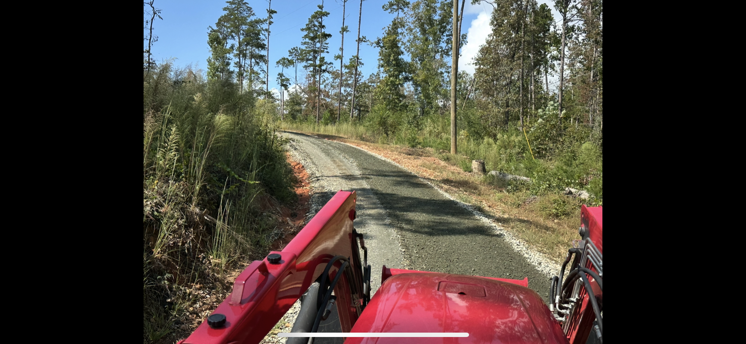Fresh gravel driveway re-crowning and restoration in progress