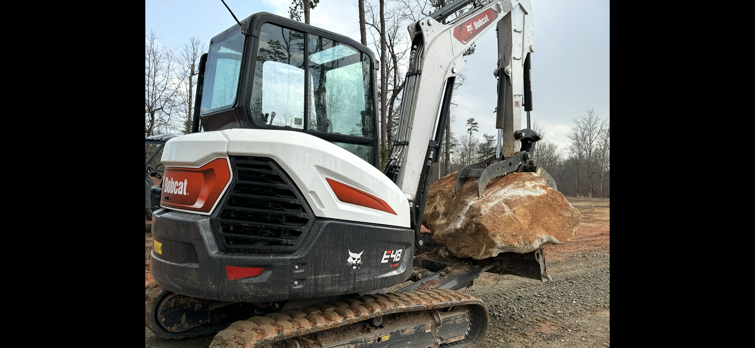 Bobcat E48 excavator with bucket during trenching work